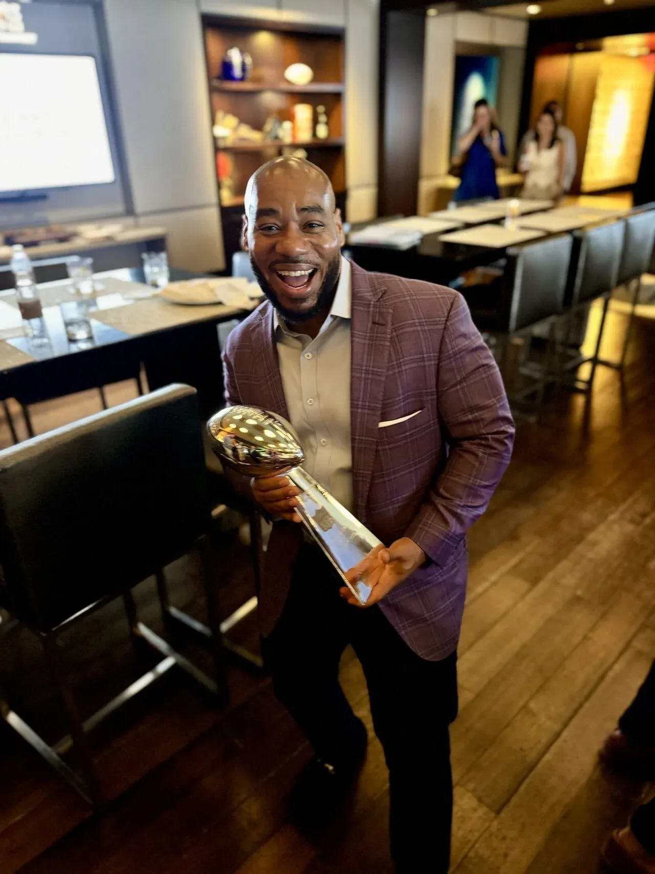 DeMarcus Strange holding an award and smiling