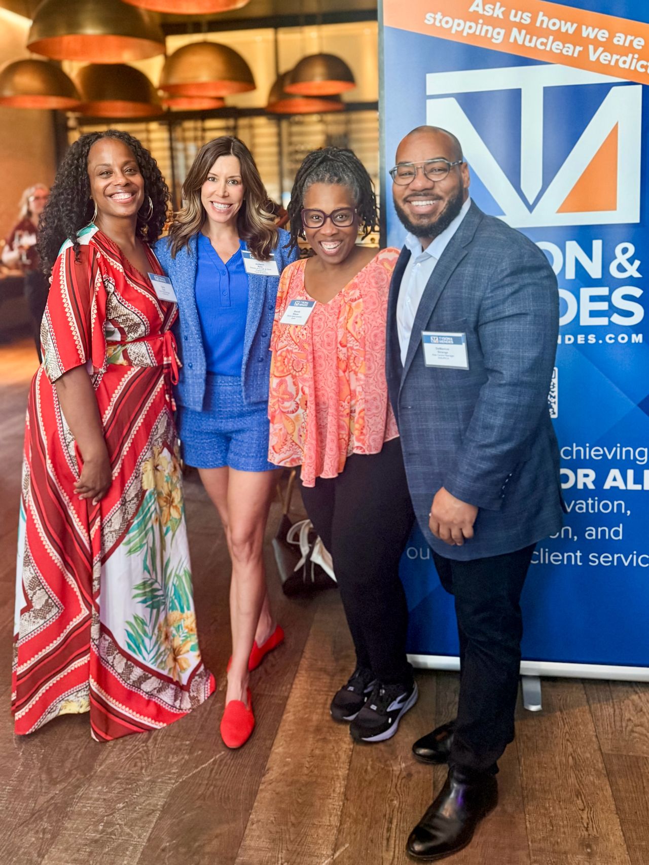 DeMarcus Strange with three professional colleagues at an industry event